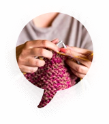 Needles loop natural fibers into cohesive garments